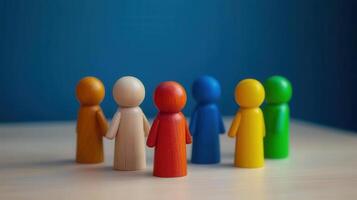 Diverse wooden figures holding hands symbolize unity and inclusion photo
