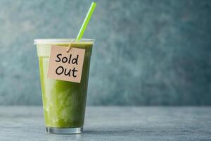 refreshing green drink in cup with Sold Out tag, showcasing vibrant colors photo