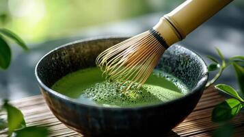 serene close up of matcha green tea preparation, showcasing bamboo whisk in bowl. vibrant green color evokes tranquility and freshness photo