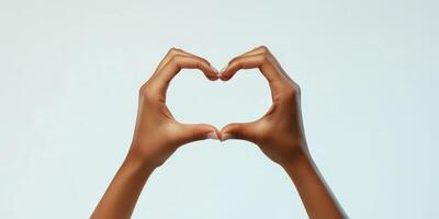 Hands forming a heart shape against a soft background conveying love and connection photo