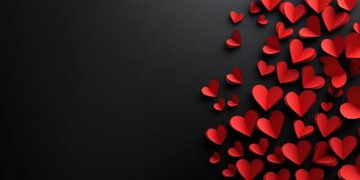 Many red hearts cascade against a black background, creating a romantic and festive atmosphere for any occasion photo