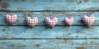 Colorful checked hearts hanging on a blue wooden background create a charming decorative display photo