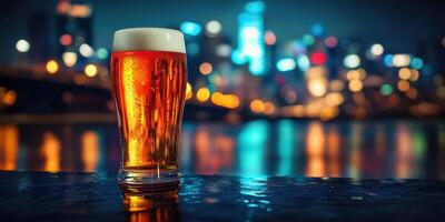 Golden beer glass illuminated against a vibrant city skyline at night photo
