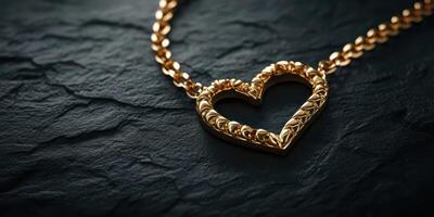 Detailed heart-shaped gold necklace with intricate design on dark stone background photo