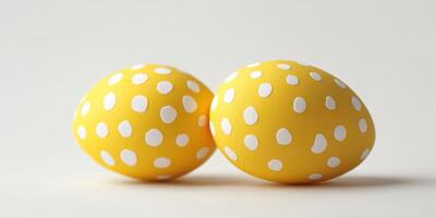 Decorative yellow eggs with white dots resting on a plain surface for spring celebrations and festivities photo