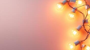 Lit christmas light bulbs hanging from a pink string against a pink wall create a warm, inviting atmosphere background Copy space for text photo