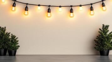 Christmas light bulbs hanging above gray tabletop with small potted pine tree creating warm holiday atmosphere background Copy space for text photo