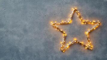 Christmas lights forming a bright star shape decoration on a pale gray background, perfect for holiday season greeting card or website banner Copy space for text photo