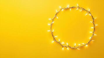Christmas lights illuminating white creating oval frame on light yellow background, perfect for winter holidays greeting card photo