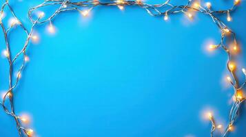Christmas lights creating a glowing frame on a blue backdrop, perfect for holiday season greetings and festive designs with copy space photo