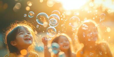 Children laughing while playing with bubbles during a sunny afternoon in a garden filled with warm sunlight photo