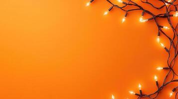 Christmas lights illuminating white frosted leaves creating frame on light orange background, perfect for winter holidays greeting card photo