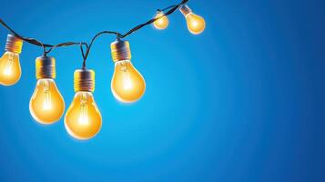 Luminous bulbs hanging from wire, emitting soft glow deep blue background, generating cozy, dramatic lighting effect Copy space for text photo