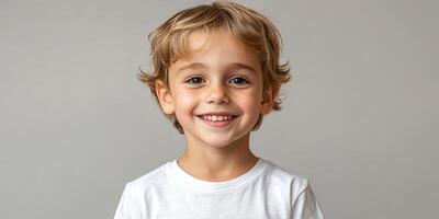 Young boy with joyful smile against a plain backdrop in a bright setting photo