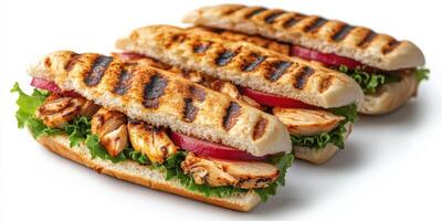 Grilled chicken sandwiches with fresh vegetables served on a white background photo