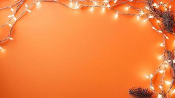 Christmas lights creating a glowing frame on a orange backdrop, perfect for holiday season greetings and festive designs with copy space photo
