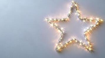 Christmas lights forming a bright star shape decoration on a pale blue background, perfect for holiday season greeting card or website banner Copy space for text photo