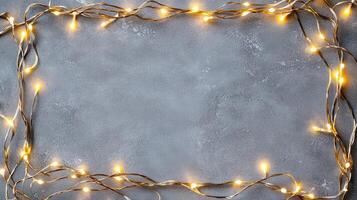 Christmas lights creating a glowing frame on a gray backdrop, perfect for holiday season greetings and festive designs with copy space photo