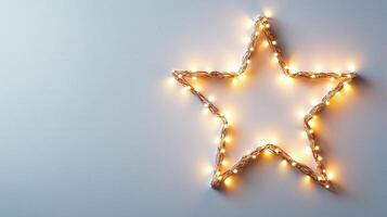 Christmas lights forming a bright star shape decoration on a pale gray background, perfect for holiday season greeting card or website banner Copy space for text photo