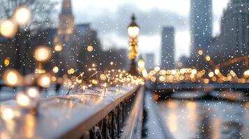 Christmas lights and colorful baubles decorating a snow covered city bridge railing at twilight, with a cityscape and falling in the background photo