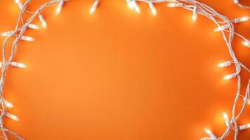 Christmas lights creating a glowing frame on a orange backdrop, perfect for holiday season greetings and festive designs with copy space photo