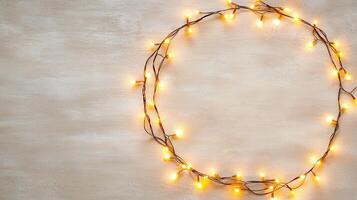 Christmas golden lights illuminating white creating frame on light blue background, perfect for winter holidays greeting card photo