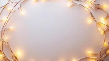 Christmas lights illuminating white creating frame on light blue background, perfect for winter holidays greeting card photo