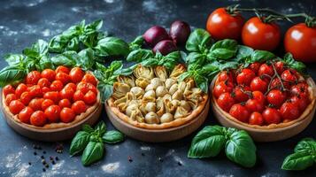 Fresh tomatoes, basil and pasta in bowls on a dark background photo
