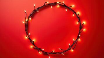 Christmas lights illuminating white creating oval frame on light red background, perfect for winter holidays greeting card photo