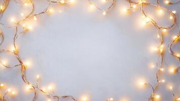 Christmas lights illuminating white creating frame on light blue background, perfect for winter holidays greeting card photo