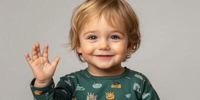 Happy toddler waving with a playful expression in a cozy indoor setting on a sunny day photo
