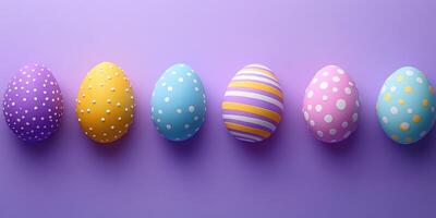 Colorful decorated easter eggs arranged on a purple background for spring festivities and celebrations photo