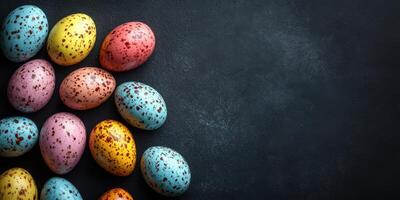 Colorful speckled eggs arranged neatly on a dark surface for festive decoration photo
