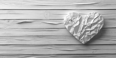 White textured heart resting on rustic wooden surface for a minimalist decor concept photo