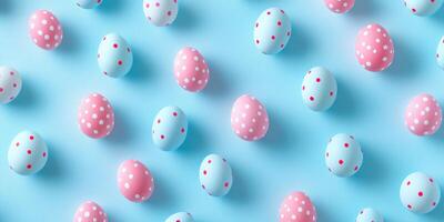 Colorful polka dot easter eggs scattered on a light blue background for spring celebrations photo