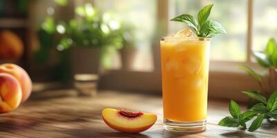 Refreshing peach beverage served in a tall glass, garnished with mint leaves, in a sunny kitchen setting photo