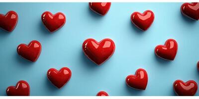 Bright red hearts scattered on a soft blue background create a cheerful and romantic atmosphere for celebrations or decorations photo