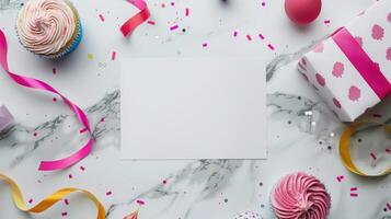 Blank card, cupcakes and present on marble table image copy space. Holiday holiday flat lay banner background blurred. Happy festive event design concept photography copyspace photo