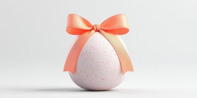 Decorative egg with a pastel orange ribbon for Easter celebrations set against a plain background photo