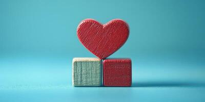 Red heart sits atop wooden blocks against a light blue background highlighting love and connection photo