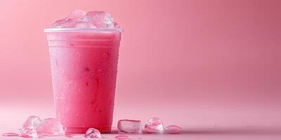 Refreshing pink drink with ice against a soft pink background during summer heat photo