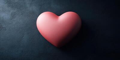 Heart shape in soft pink color against dark textured background illustrating love and affection photo