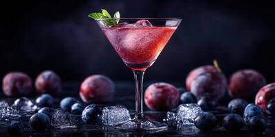 Refreshing berry cocktail served in a martini glass garnished with mint leaves on a dark background photo