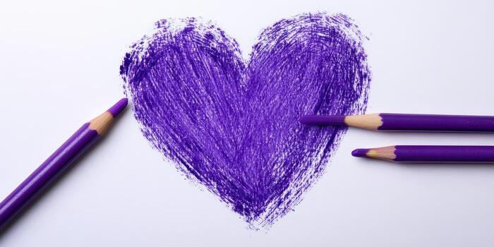 Vibrant purple heart drawn with colored pencils on white paper in creative art activity photo