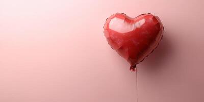 Heart-shaped balloon decorating a soft pink wall for celebration or romantic occasion photo
