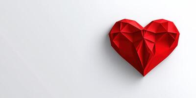 Red origami heart representing love crafted from paper placed on a clean, white background photo