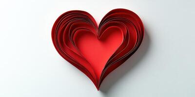 Intricate red paper heart carefully layered for decoration or crafting activities photo