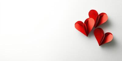 Colorful paper hearts arranged artistically on a plain background for decoration or celebration photo