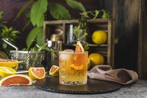 Refreshing paloma cocktail with grapefruit and ice on slate photo