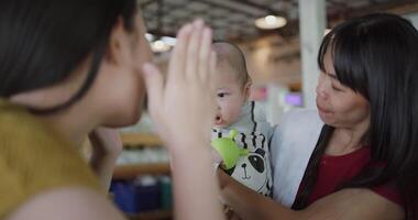 Happy family having fun with little son at table in cafe. video